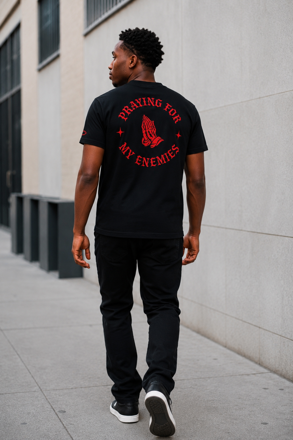 Praying for My Enemies Premium Design Tee — red graphic on street model